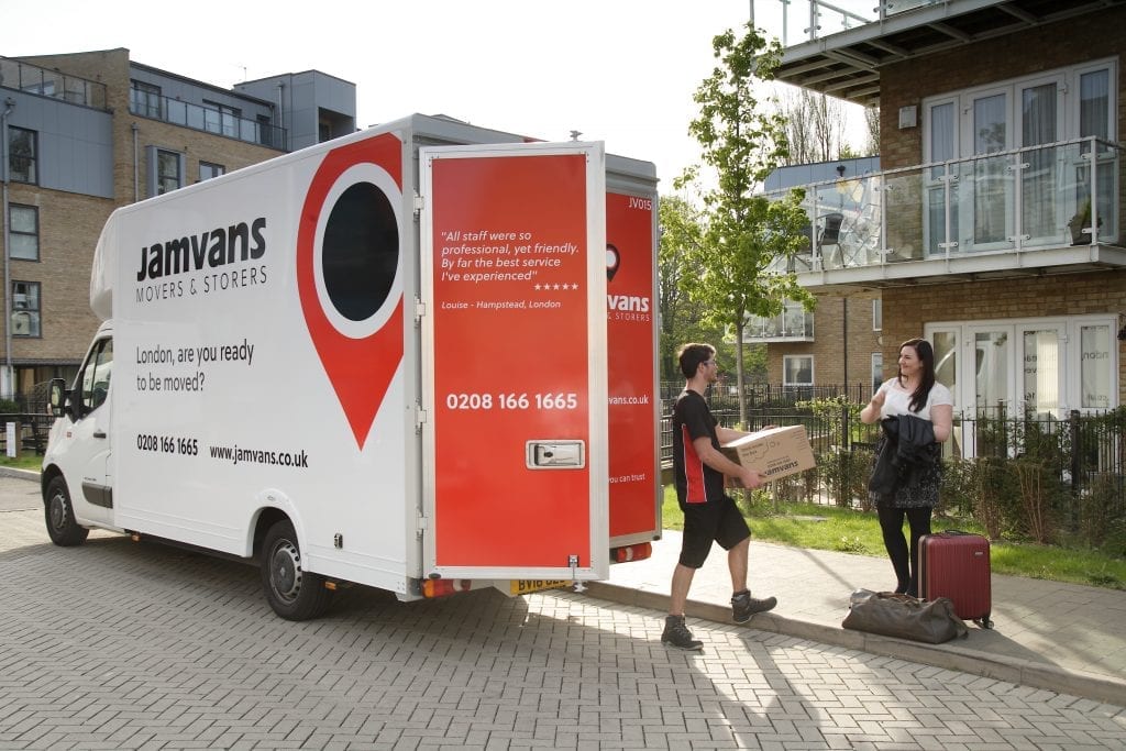 Removal men unloading belongings from a JamVans van