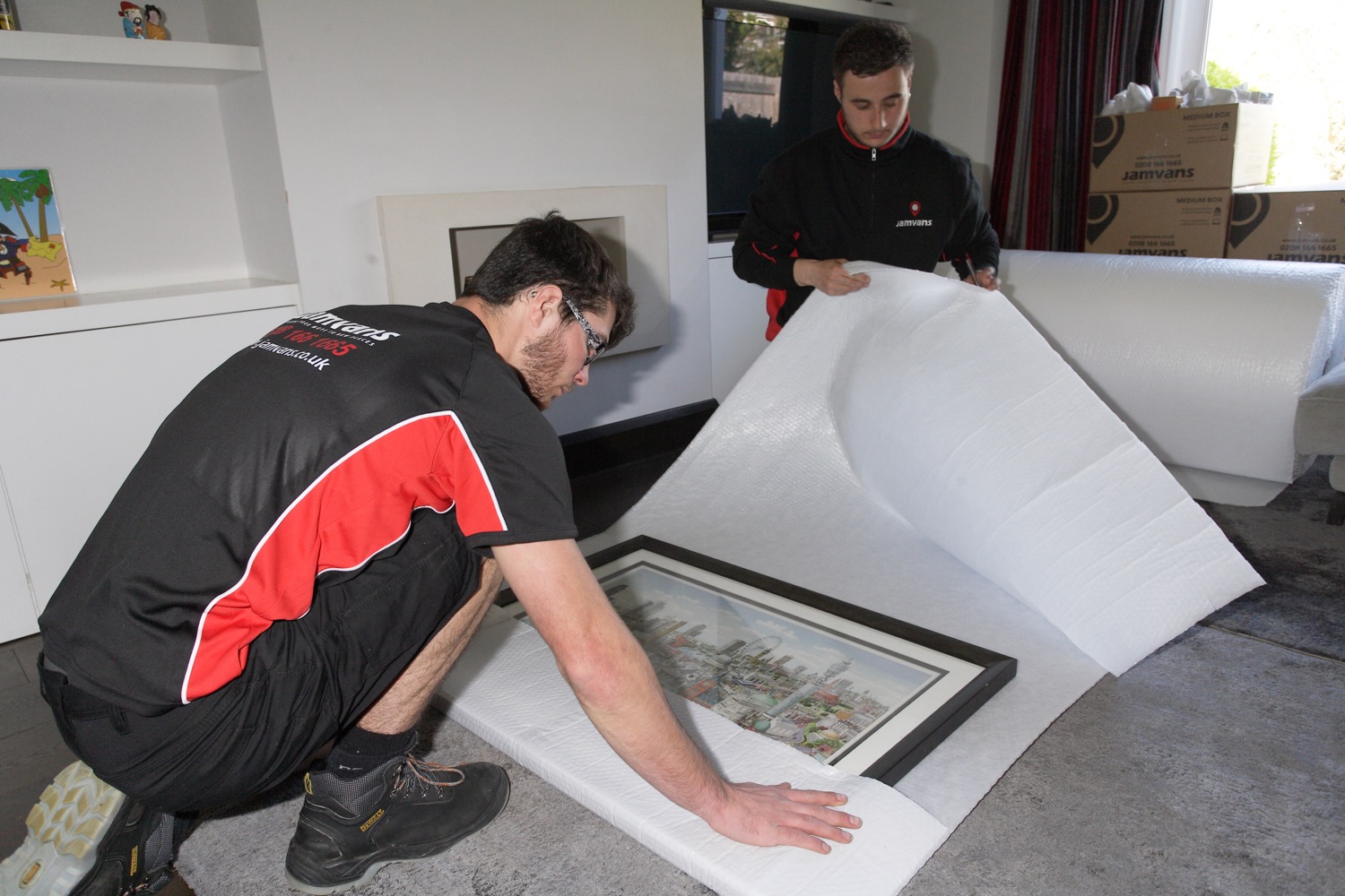 Removals man wrapping up a picture